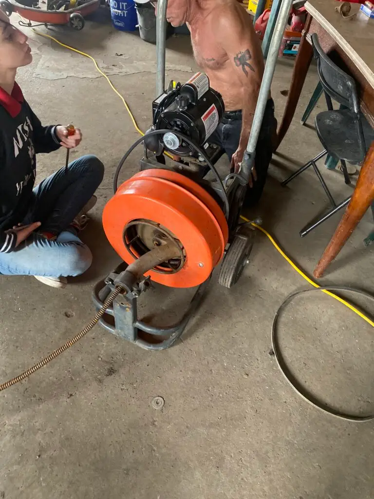Michael B Plumbing technicians servicing a Spartan 92 sewer machine at the company shop in New Iberia, Louisiana