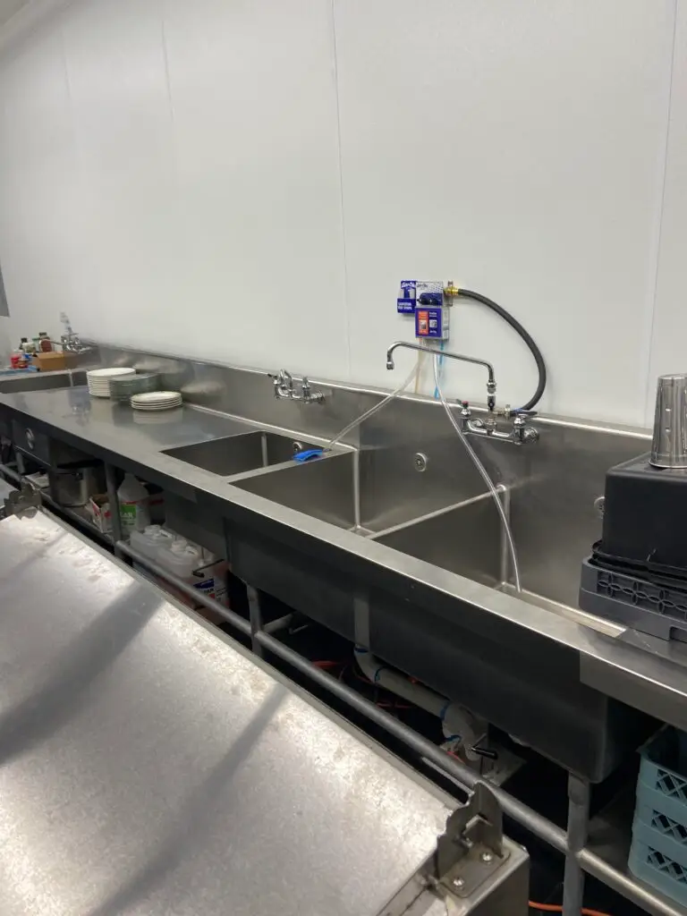 Three-compartment commercial sink installed at Bambino’s Burgers restaurant in New Iberia, Louisiana