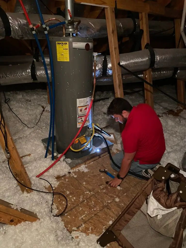 Gas water heater repair in an attic near Sugar Ridge in Youngsville, Louisiana