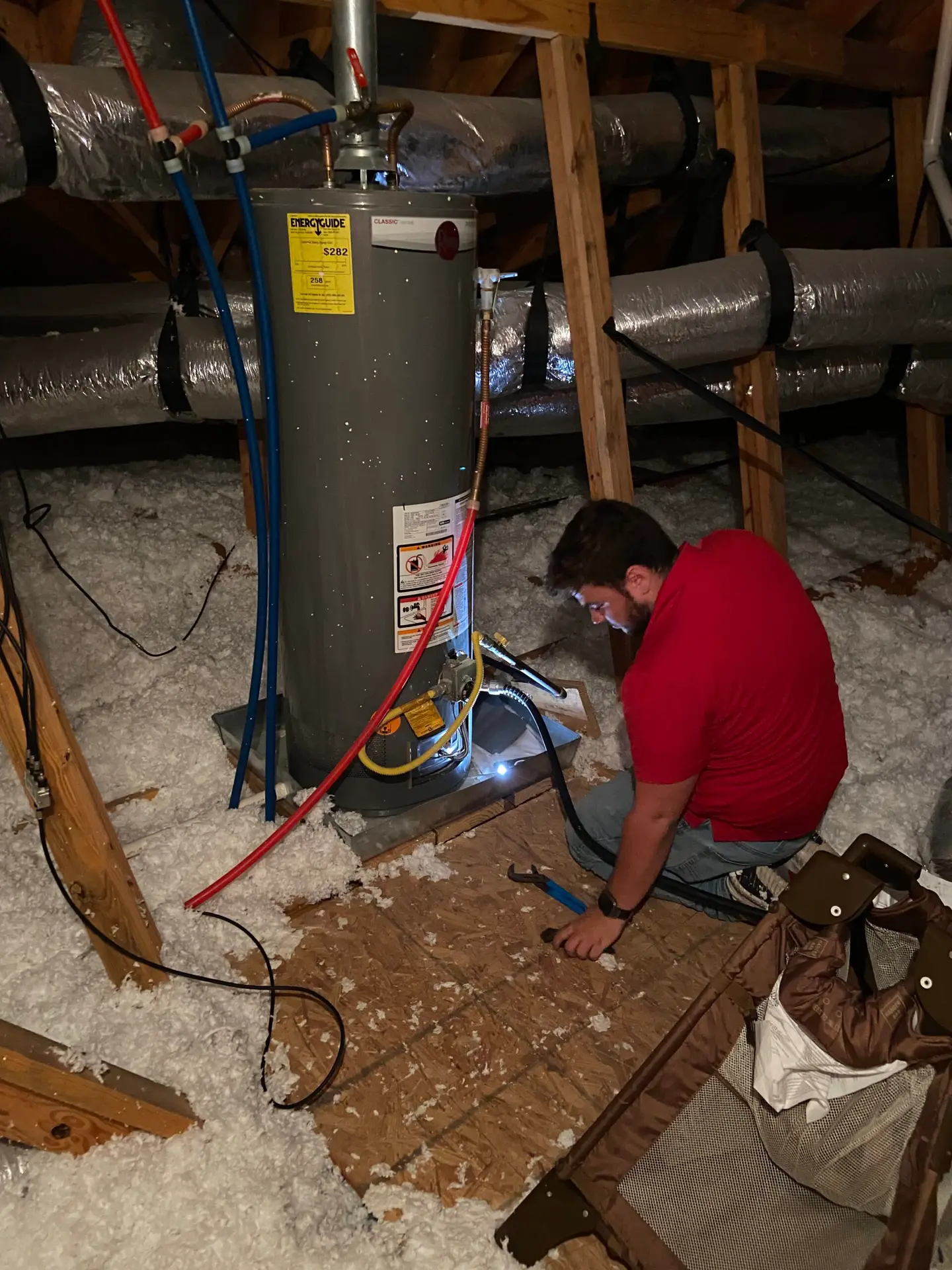 Gas water heater repair in an attic near Sugar Ridge in Youngsville, Louisiana
