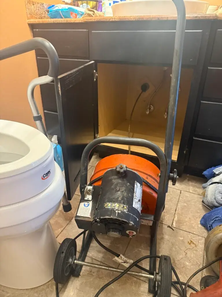 Alternate view of a bathroom drain being cleared with a cable machine in Franklin, Louisiana
