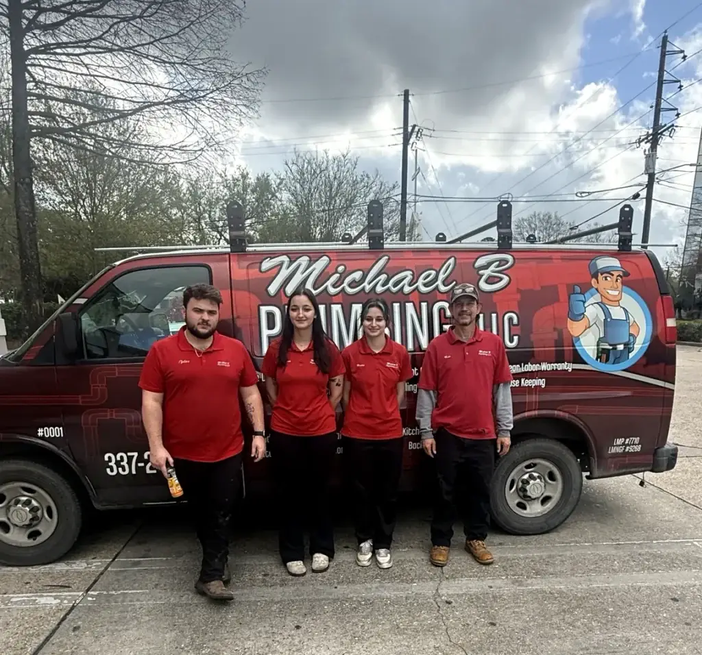 Michael B Plumbing team standing in front of a branded service van