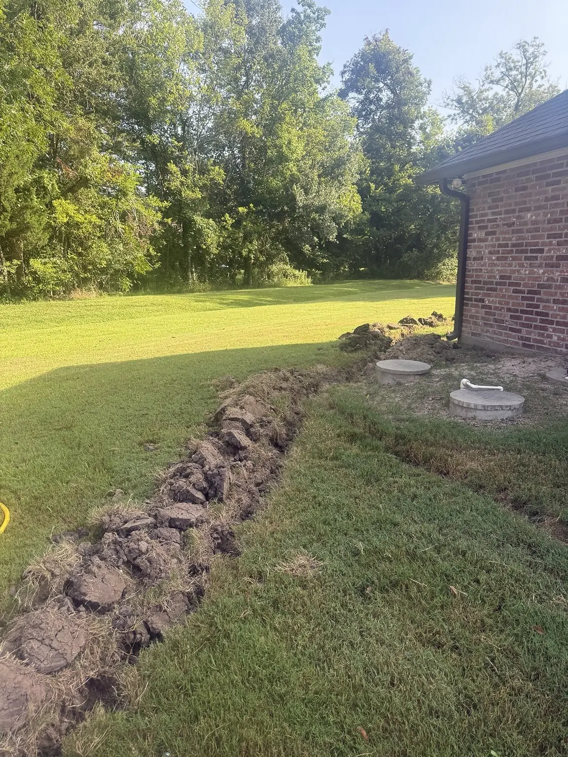 Residential trench prepared for an underground gas line replacement in Breaux Bridge, Louisiana