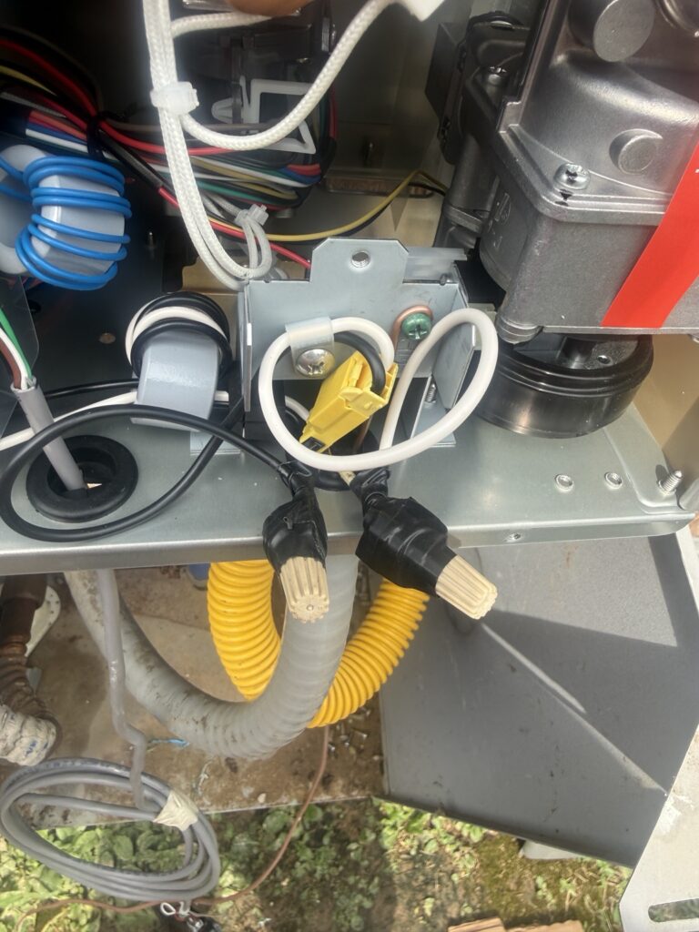 Internal connection detail during an outdoor Rheem tankless water heater replacement in Lafayette, Louisiana