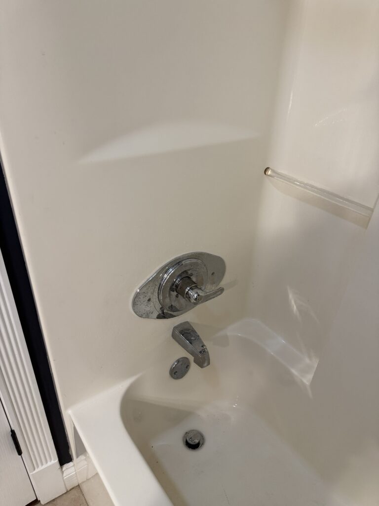 After photo of a three-handle tub and shower faucet converted to a single-handle faucet with chrome remodel plate in New Iberia