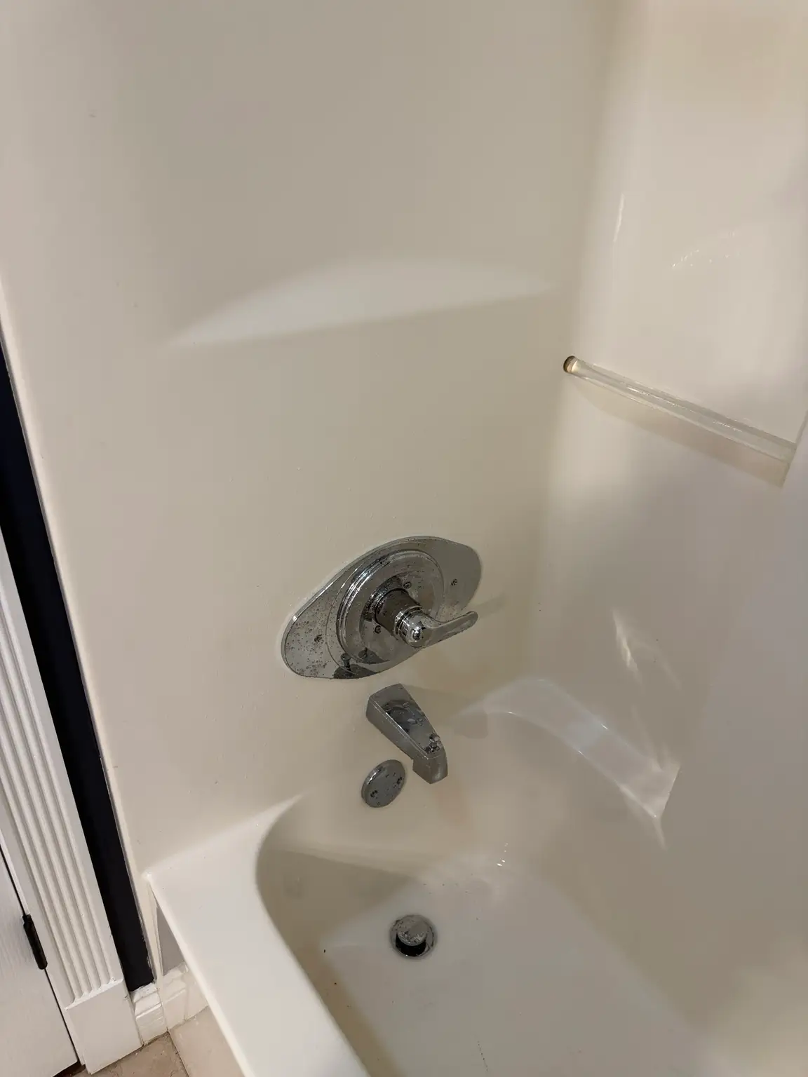 After photo of a three-handle tub and shower faucet converted to a single-handle faucet with chrome remodel plate in New Iberia